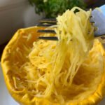 Microwaved spaghetti squash served in its shell, with fork pulling strands