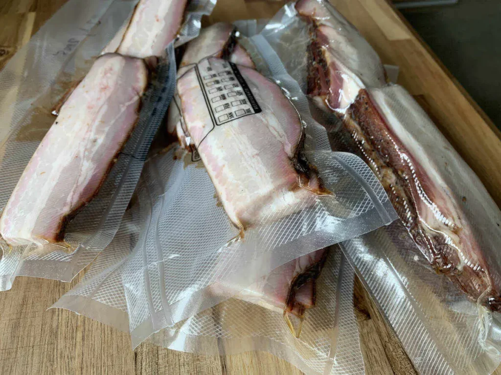 Vacuum-sealed bacon packages, ready to be stored in the freezer for future use.