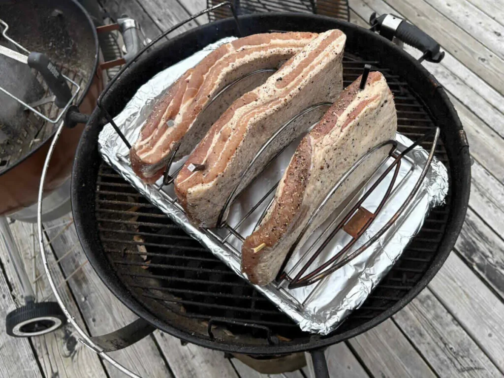 Raw pork belly placed on a rack, ready to be smoked for homemade AIP bacon.