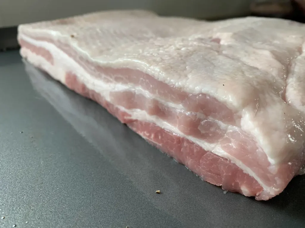 Fresh, unseasoned pork belly ready to be cured for homemade AIP bacon.