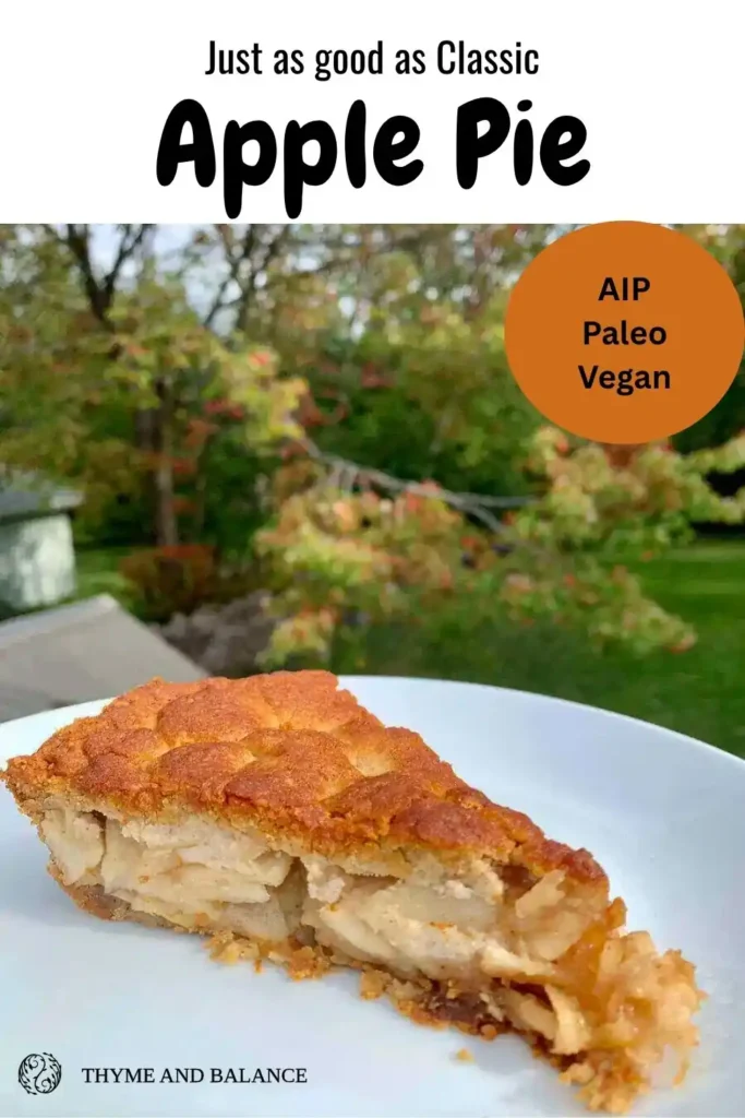 Slice of apple pie on a white plate with a tree in the background. Text reads "as good as classic apple pie, AIP, Paleo, Vegan"