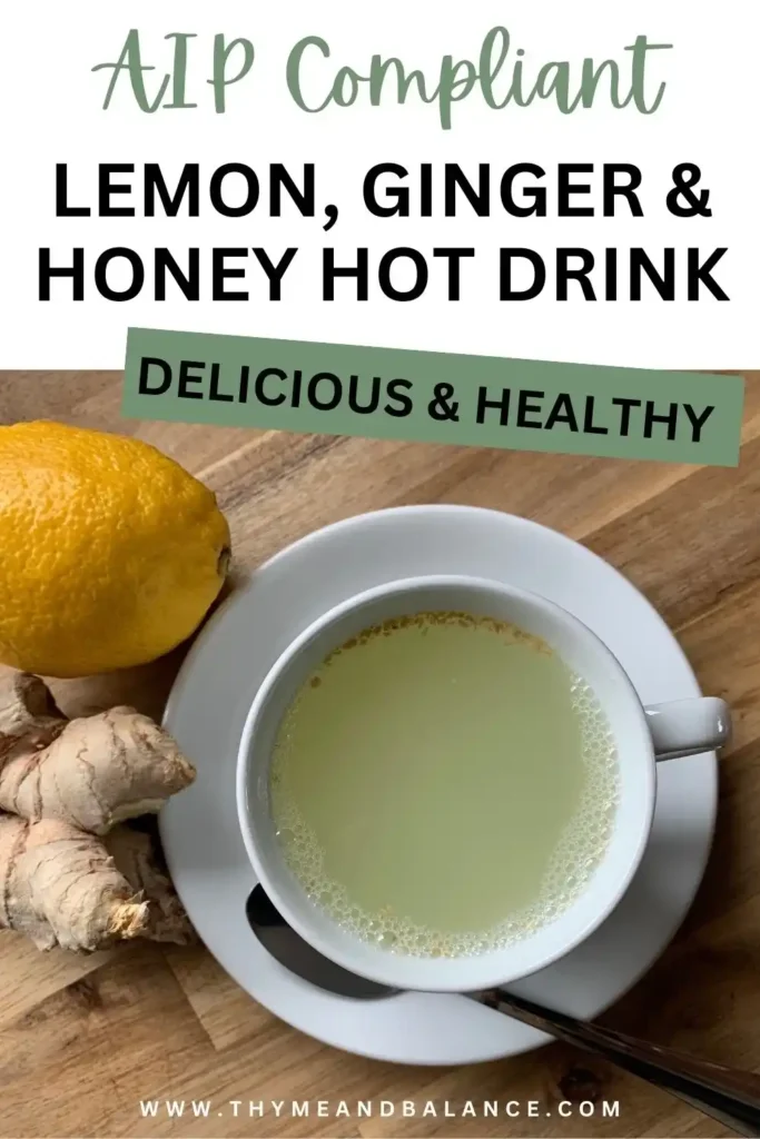 Image of a white cup with a lemon, ginger and honey drink next to a fresh ginger and lemon. Text overlay reads AIP compliant lemon, ginger and honey hot drink. Delicious and Healthy by thymeandbalance.com