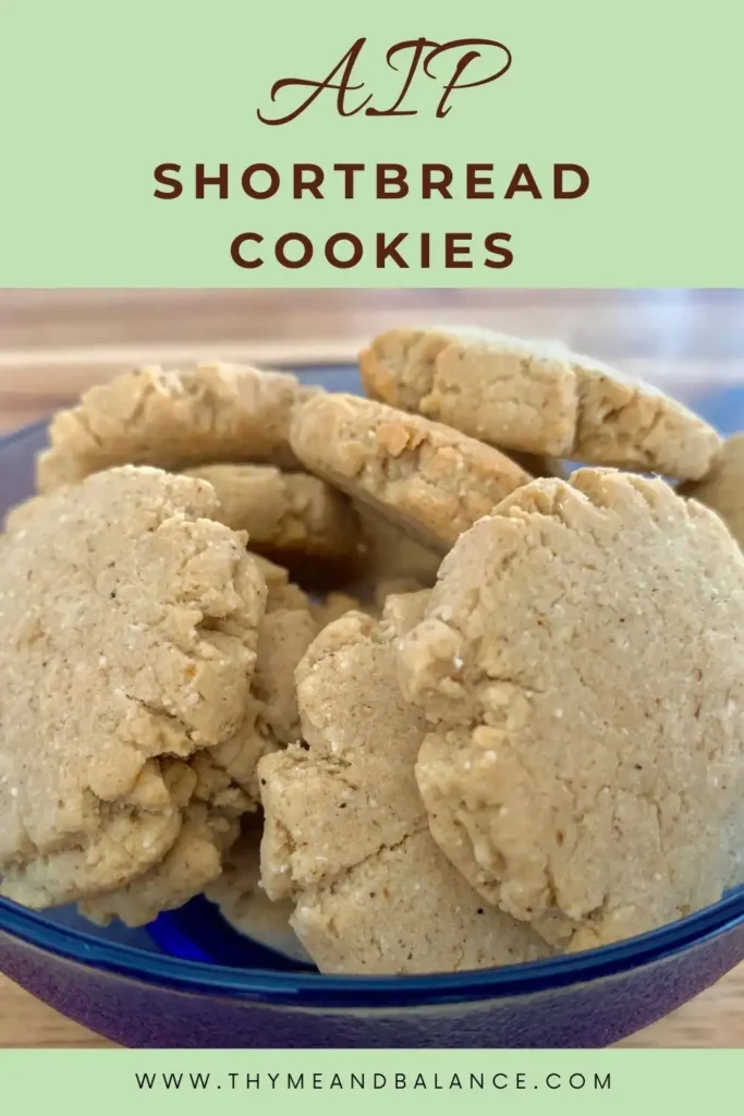 Cookies in a blue bowl with text overlay that reads AIP Shortbread Cookies by thymeandbalance.com