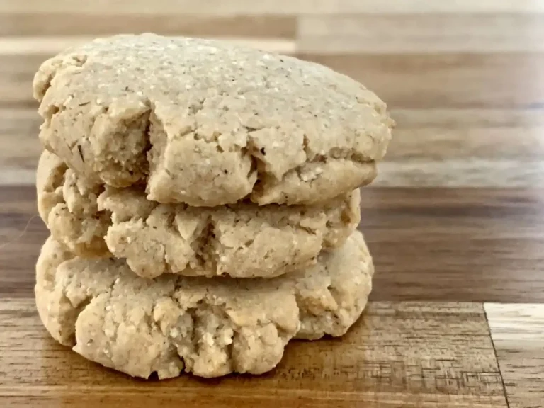 Three AIP shortbread cookies sticked on top of each other sitting on a wooden counter