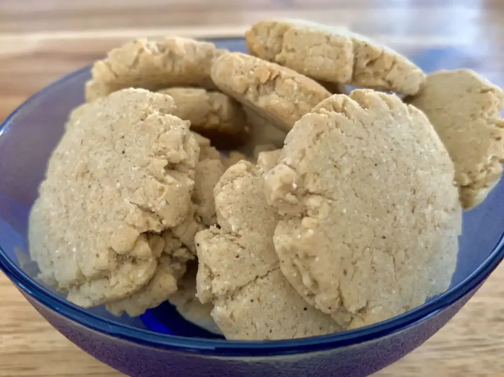 AIS shortbread cookies in a blue glass bowl on a wooden counter