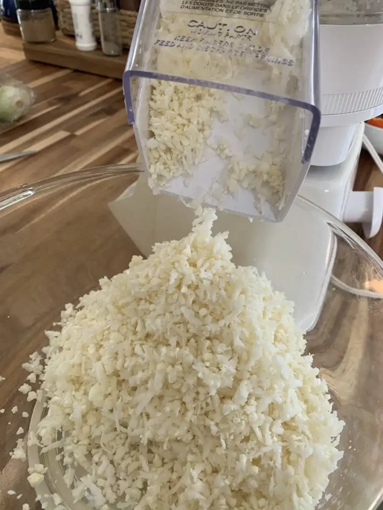 Ricing cauliflower for cauliflower rice in a food processor.
